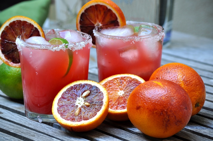 Best Margarita Mixes for Pitcher Margaritas Close Up of Two Blood Orange Margaritas Next to Blood Oranges