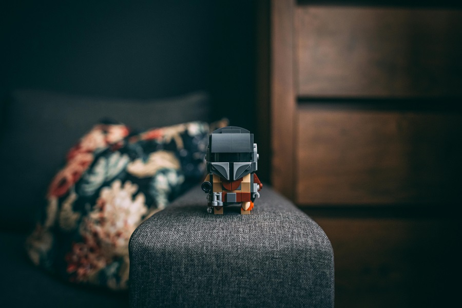 Best Star Wars Gifts for Guys a Mandalorian Lego on a Couch Arm