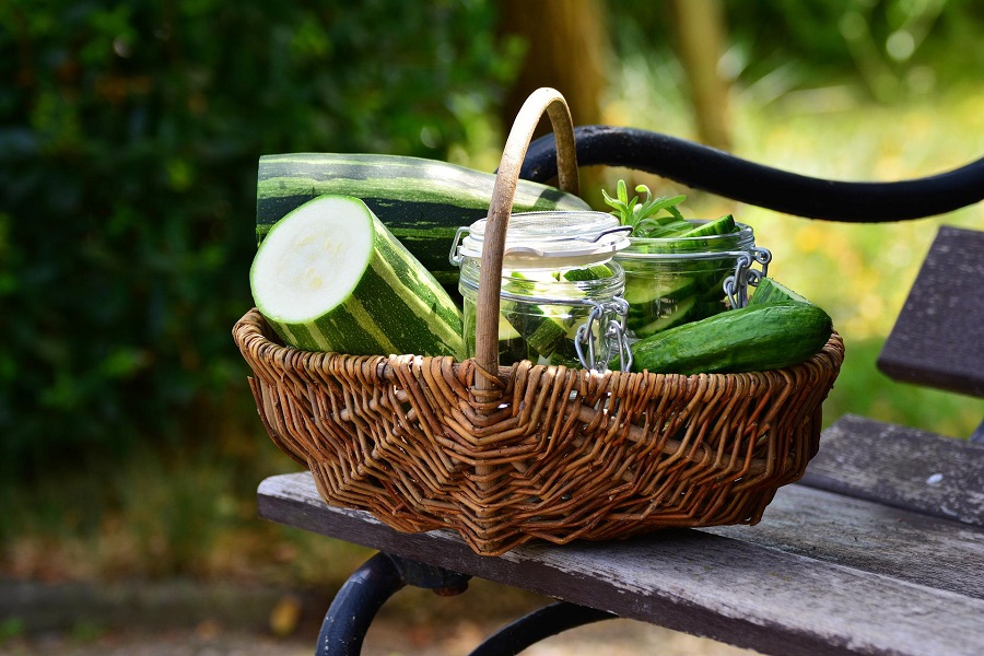 Snacks for Weight Loss to Carry with You Zucchini Sitting in a Basket Outside on a Wooden Table