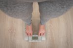 Ways to Lose Water Weight Downward View of a Woman Standing on a Scale