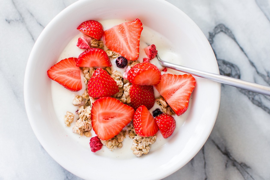 Best Whole30 Breakfast Recipes Overhead Bowl of Yogurt ith Oats and Sliced Strawberries