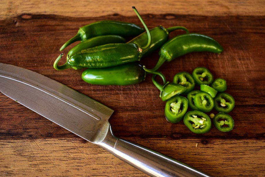Best Man Snacks to Keep on Hand Jalapenos on a Wooden Cutting Board Next to a Knife