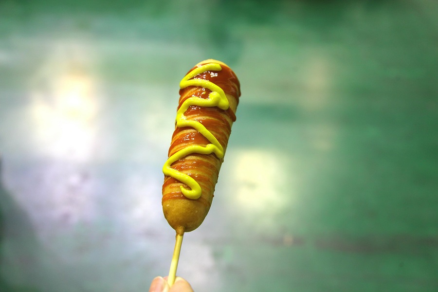 Man Snacks to Keep on Hand Corn Dog With Mustard and Ketchup