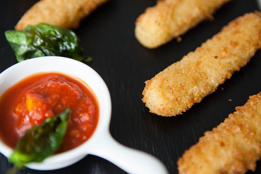 Man Snacks to Keep on Hand Mozzarella Sticks and a Dish of Marinara Sauce