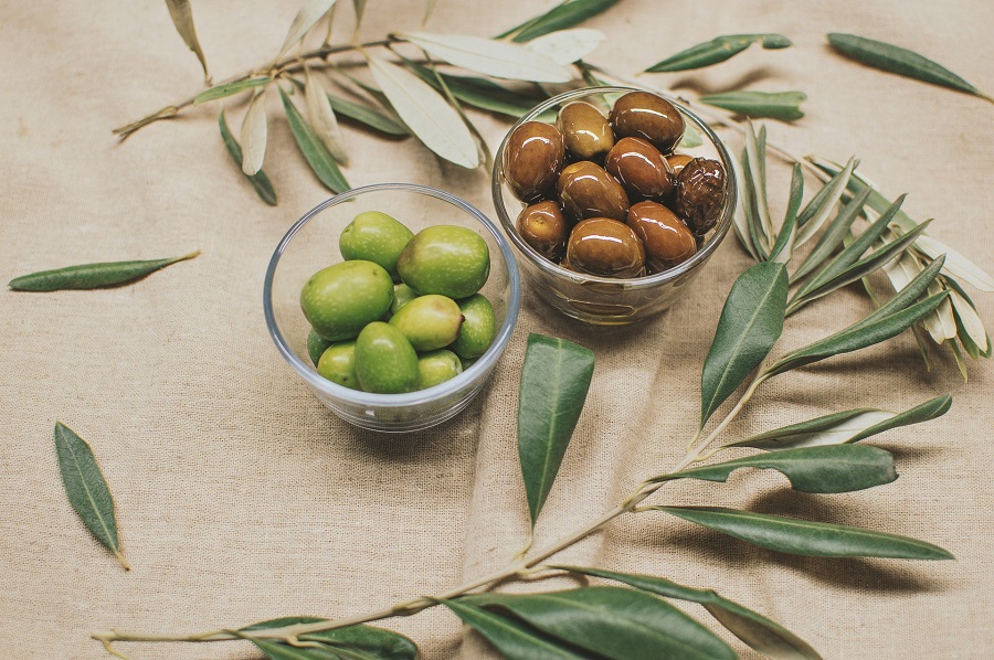 Man Snacks to Keep on Hand Two Small Bowls Each Filled with Different Types of Olives