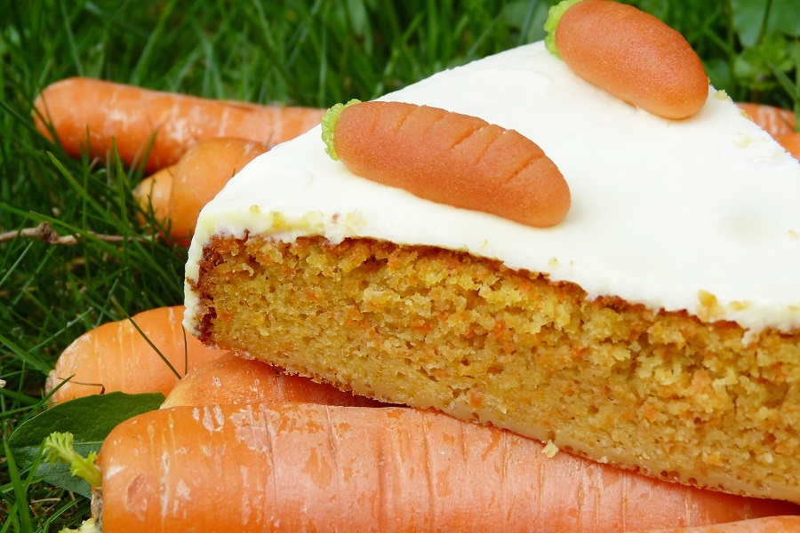 Gluten Free Desserts Close Up of a Slice of Carrot Cake Sitting on Top of Carrots