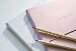 Bullet Journal Ideas to Improve Your Health Close Up of Two Bullet Journals on a Table