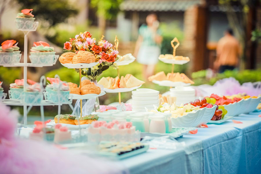 Baby Boy Gift Ideas a Table of Food at a Party Outdoors