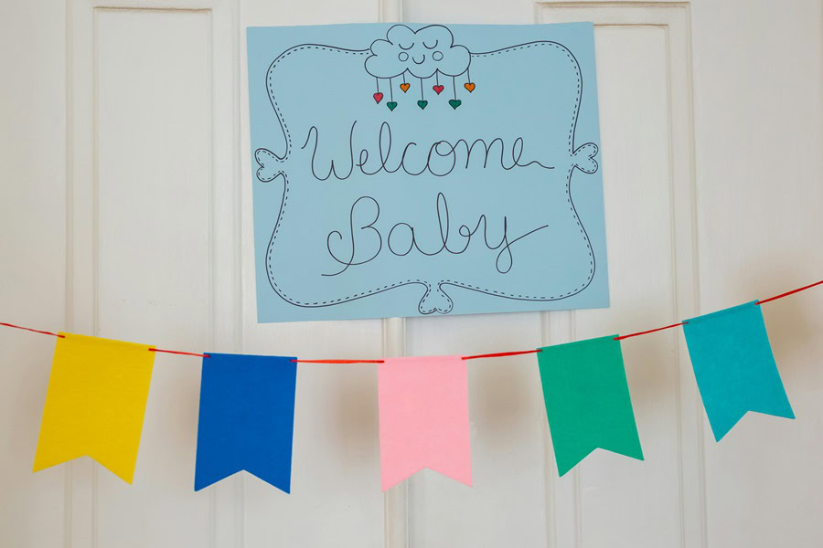 Baby Boy Gift Ideas a "Welcome Baby" Sign on Blue Paper