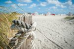 Beach House Home Decor Ideas for a Coastal Retreat Close Up of a Pillar at a Beach with a Rope Tied Around It
