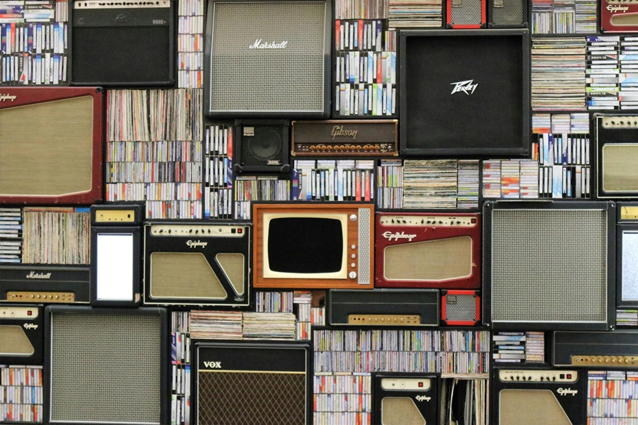 10 Songs to Listen to When you Want to Make a Deal an Array of Speakers and Amps on a Wall of Tapes