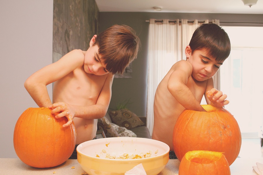 Pumpkin Carving Ideas for Halloween Two Little Boys Cleaning Out Their Pumpkins in a Kitchen