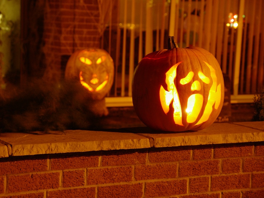 Pumpkin Carving Ideas for Halloween Two Carved Pumpkins with Lights Inside Sitting on a Brick Stairway