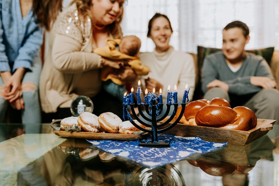 Mensch on a Bench Rules a Family Celebrating Hanukkah Together