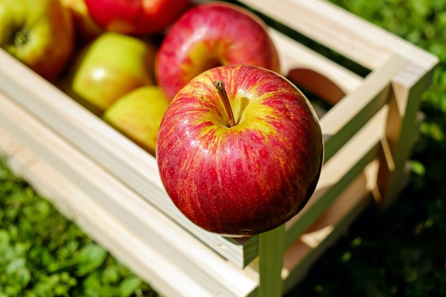 Apple Dessert Recipes Close Up of a Red Apple on a Crate of Apples