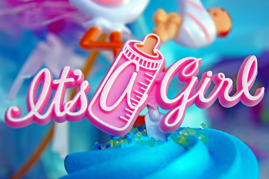 DIY Gender Reveal Ideas Close Up of a Blue Cupcake with a Small Sign That Says It's a Gril