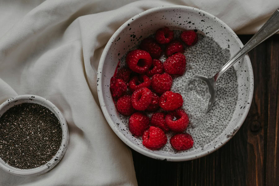 Clean Eating Breakfast Recipes for Beginners Close Up of a Bowl of Yogurt with Chia Seeds and Raspberries 