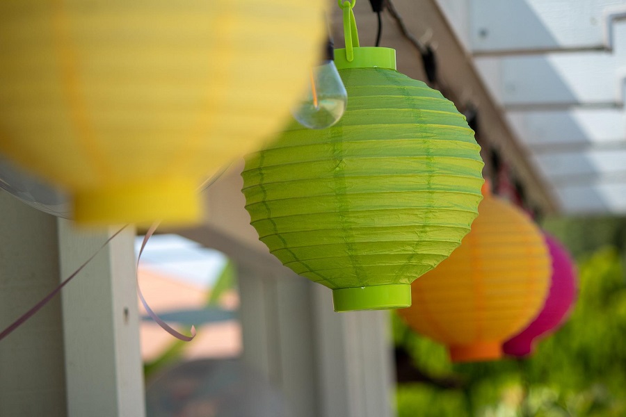 Party Planning Checklist Printables Close Up of Colorful Paper Lanterns Strung Up Along a House