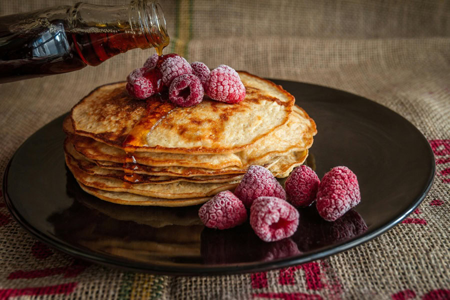 Clean Eating Breakfast Recipes a Black Plate with a Short Stack of Protein Pancakes with Raspberries 