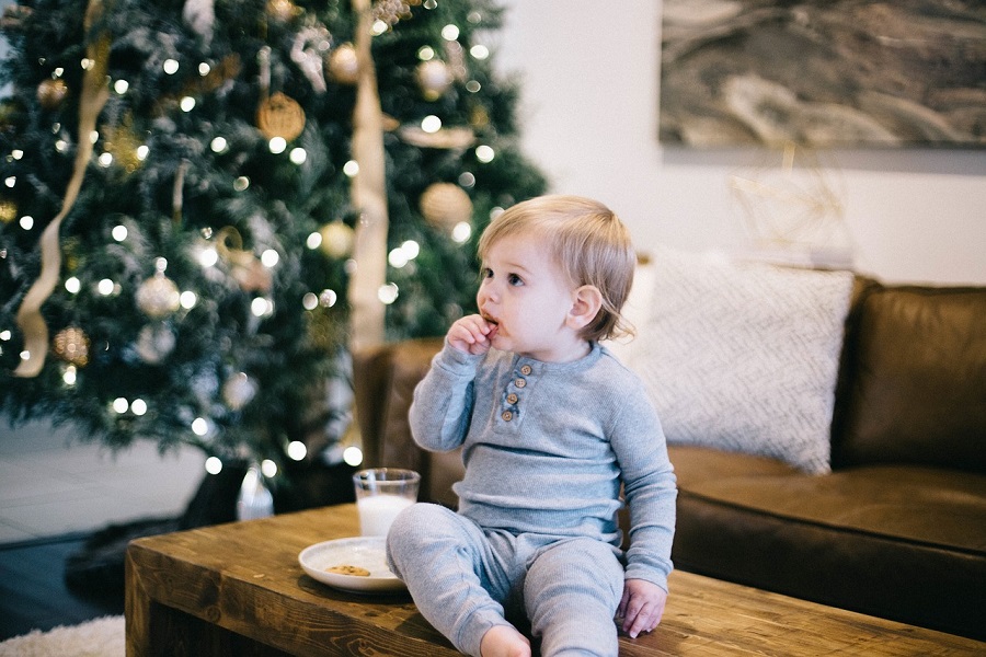 12 Days of Christmas Quotes for Kids a Toddler Sitting on a Coffee Table in Front of a Christmas Tree