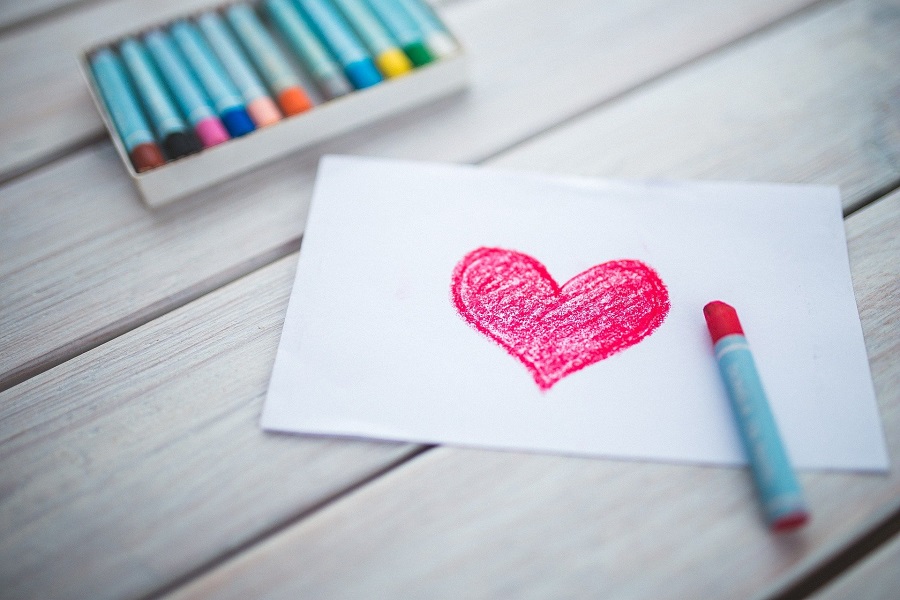 DIY Valentine's Day Party Decorations for Kids A Piece of Paper with a Heart Drawn on it Sitting on a Table with a Box of Crayons Nearby