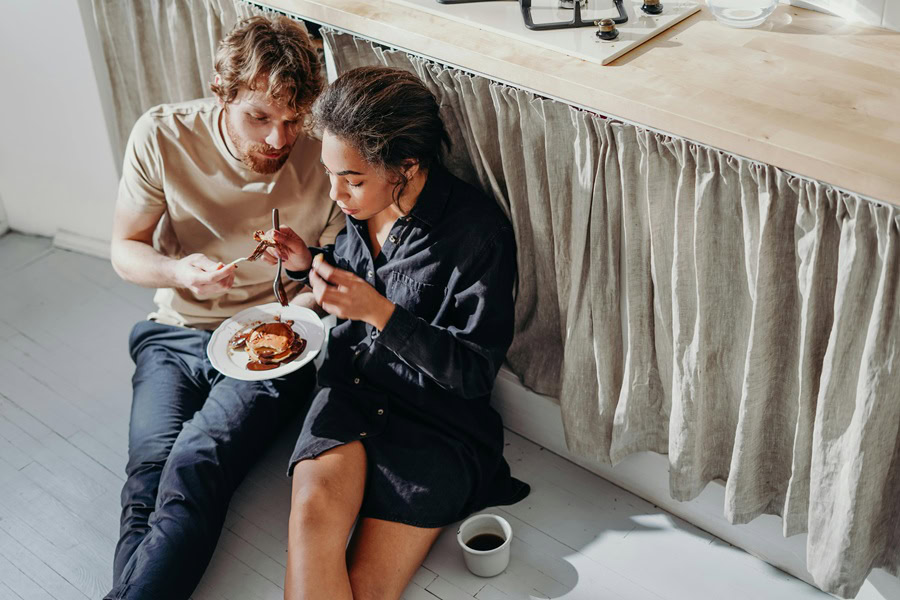 Sexy Valentine's Day Nail Ideas a Couple Sitting on the Floor Together in a Kitchen Sharing Breakfast