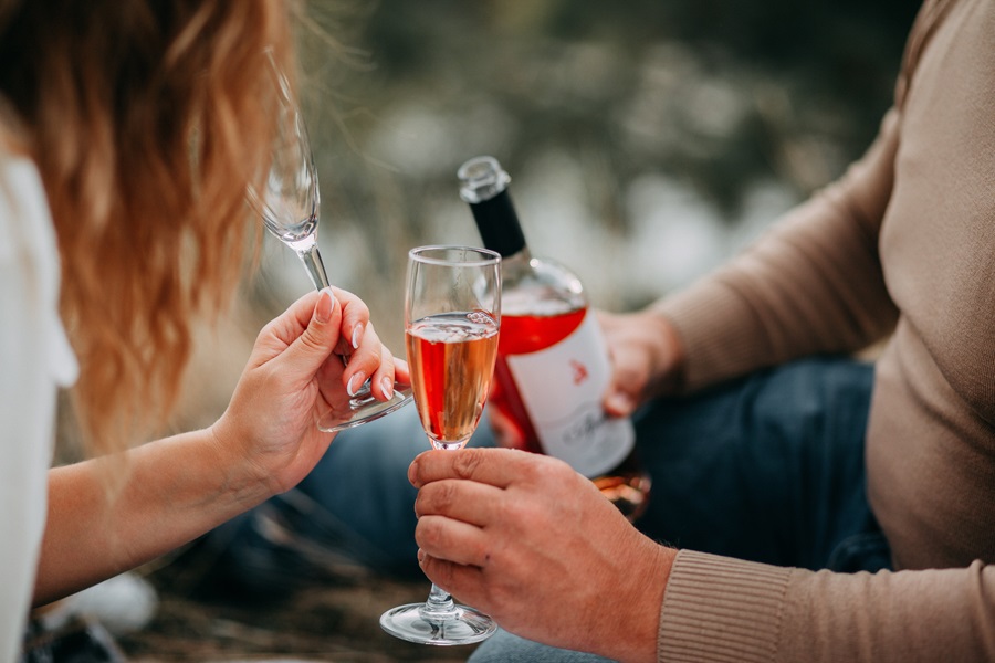 Sexy Valentine's Day Nail Ideas a Couple Enjoying a Bottle of Wine in a Park