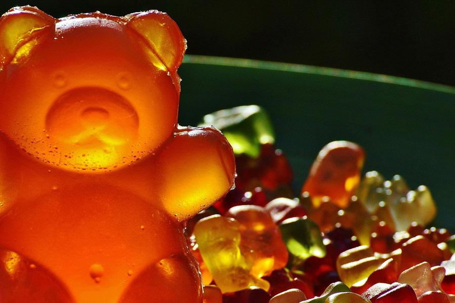Sparkling Rosé Gummy Bear Recipes Close Up of a Big Gummy Bear Sitting on Top of a Pile of Smaller Gummy Bears
