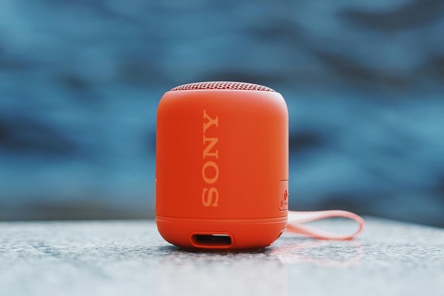 Summer Party Essentials Shopping List a Bluetooth Speaker on the Edge of a Pool