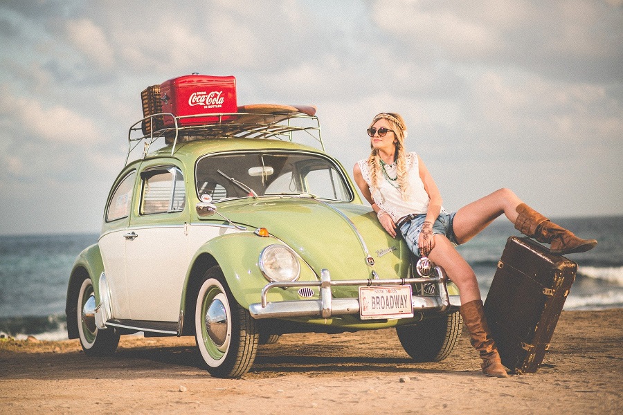 Photography Poses Woman Posing on the Hood of a Car on a Beach with Luggage