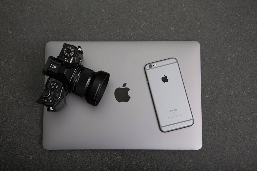 Best Aesthetic Phone Wallpaper Quotes an Apple Laptop with a DSLR Camera and an iPhone on Top of it