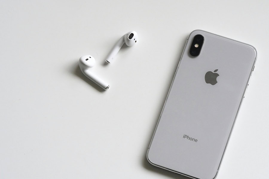 Best Aesthetic Phone Wallpaper Quotes an iPhone Face Down on a White Surface Next to Air Pods