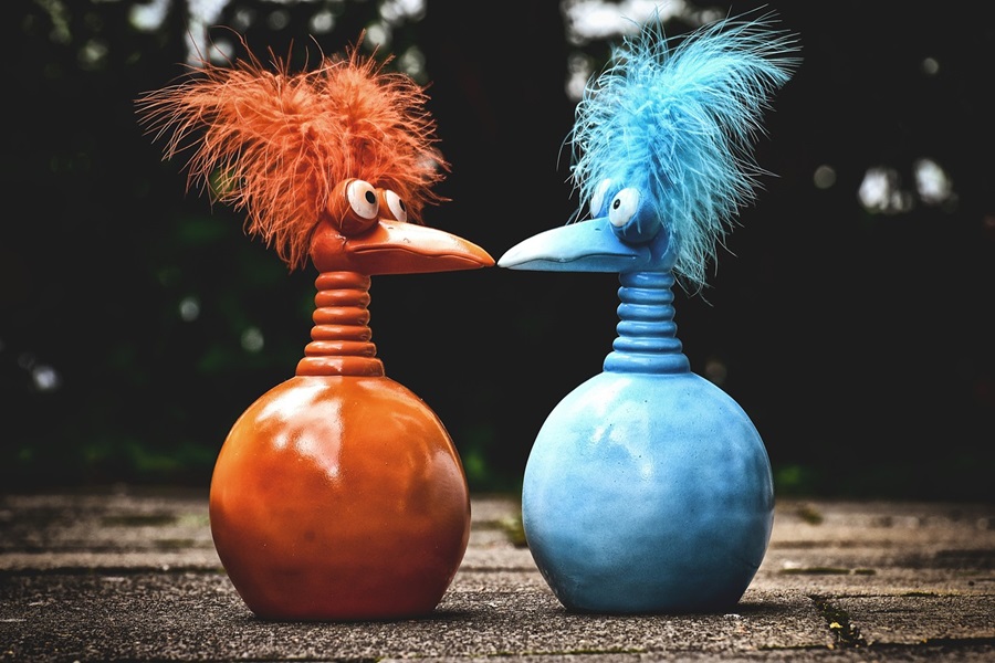 Losing Your Mind Quotes to Take the Edge Off Two Toy Bird-Like Creatures Sitting Outside One Red and One Blue with Feather Hair and Bowling Pin Bodies