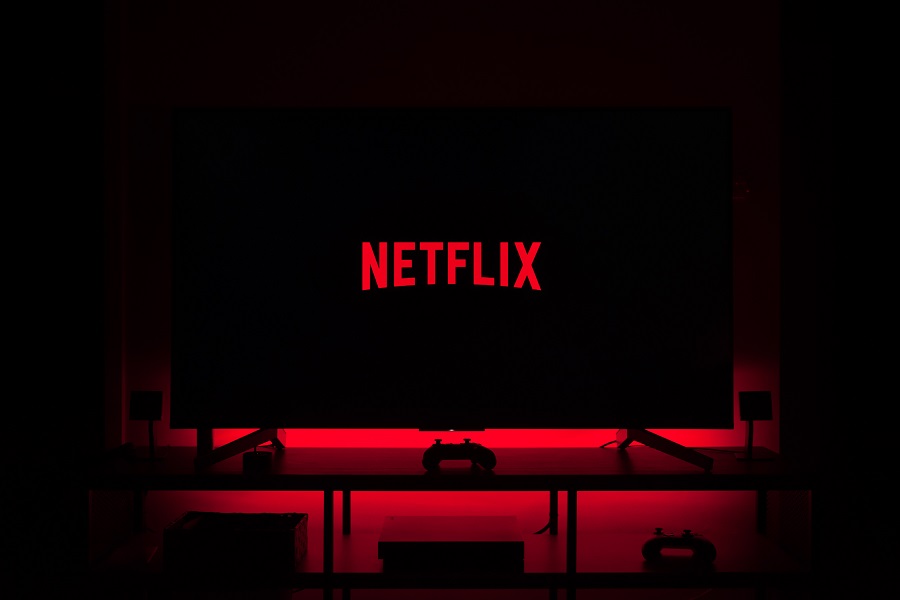 Netflix Series for Teens a TV in a Dark Room with the Netflix Logo on it and a Red Light Behind the TV