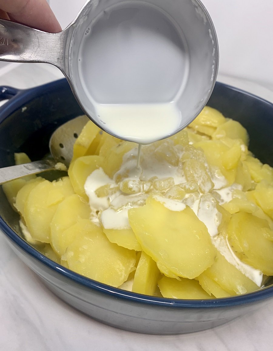 Instant Pot Scalloped Potatoes Cream Poured onto Potaotes