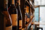 Wine Etiquette Tips Close Up of Wine Bottles on a Shelf