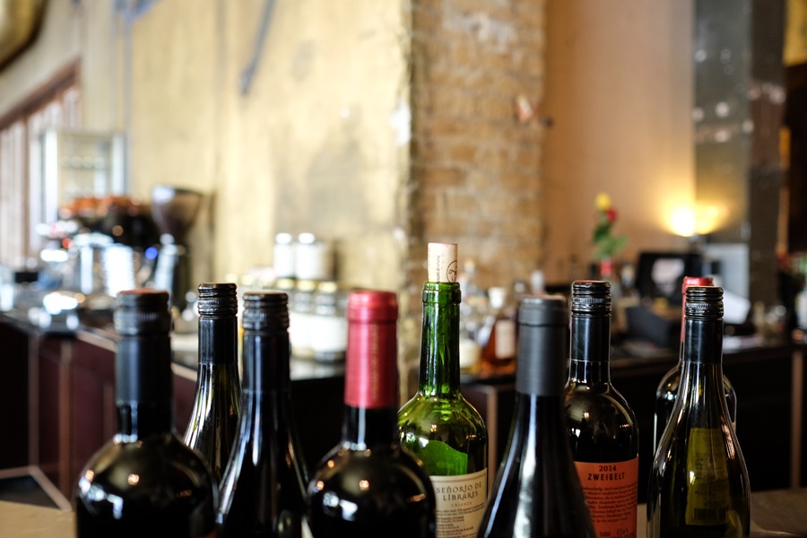 Wine Etiquette Tips Several Wine Bottles Sitting on a Bar in an Old-Style Building