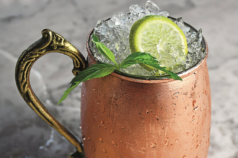 Best Things to Know About Moscow Mules Close Up of a Moscow Mule Garnished with a Lime Slice on a Granite Counter Surface