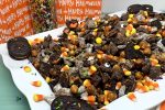 Halloween Puppy Chow Recipe Finished on a Platter with Treat Bags in the Background