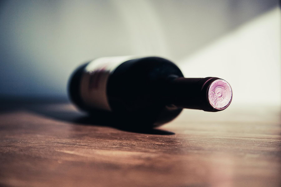 How Long Wine Lasts After Opening a Bottle of Wine on its Side on a Wooden Surface