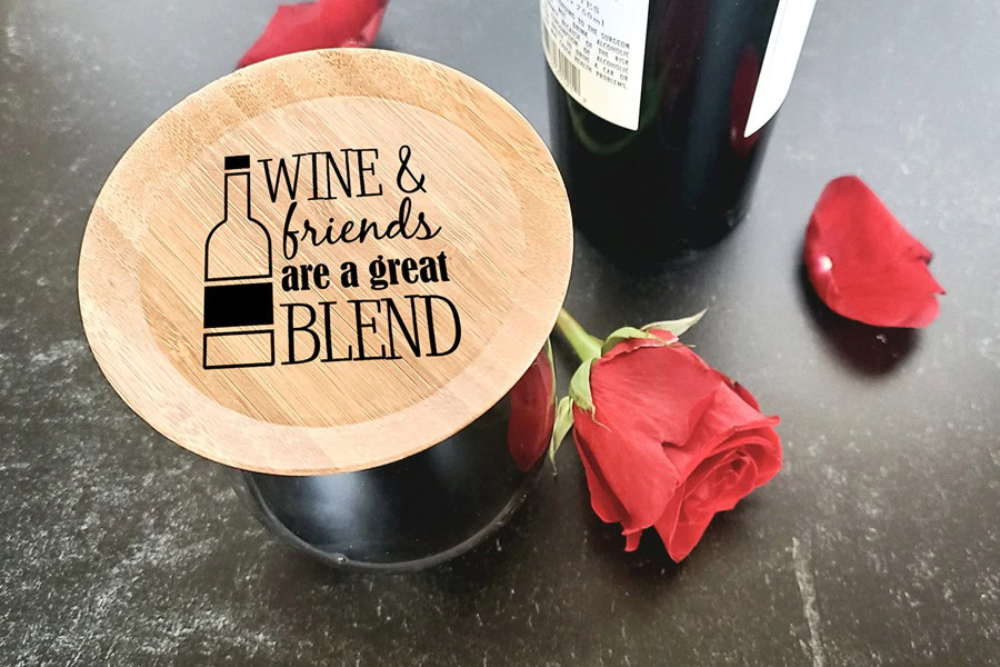 Best Wine Glass Toppers Close Up of a Wine Topper on a Glass That Says, "Wine & Friends are a Great Blend" Next to a Rose and a Wine Bottle