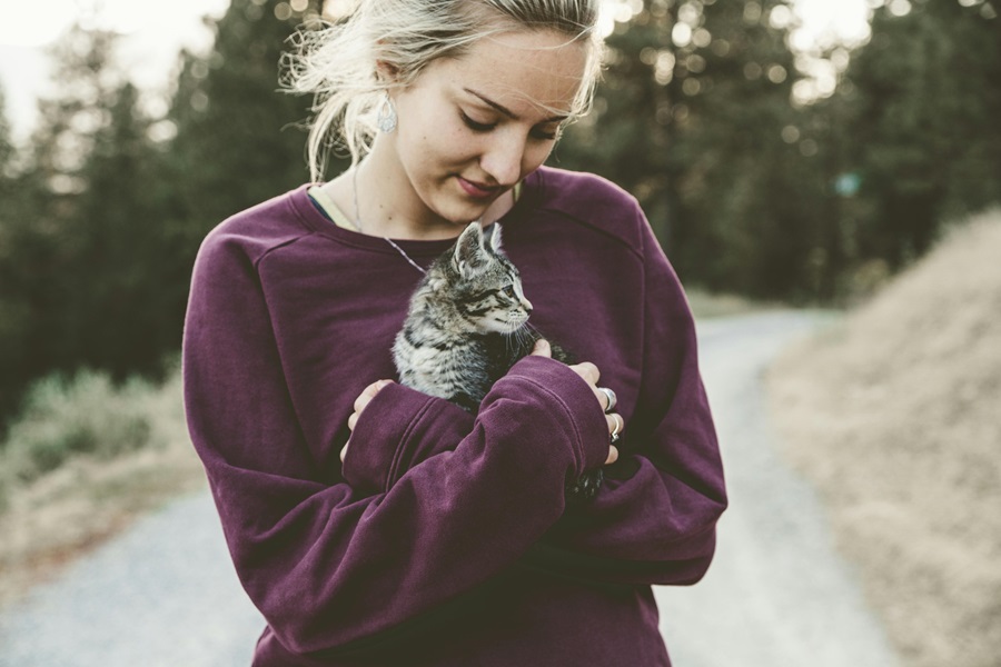 Cat Quotes for Mother's Day a Woman Standing Outside Holding Her Cat in Her Arms