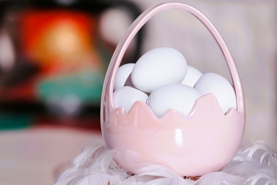 Easter Basket Ideas for Girls Close Up of a Small Pink Glass Basket with White Eggs Inside