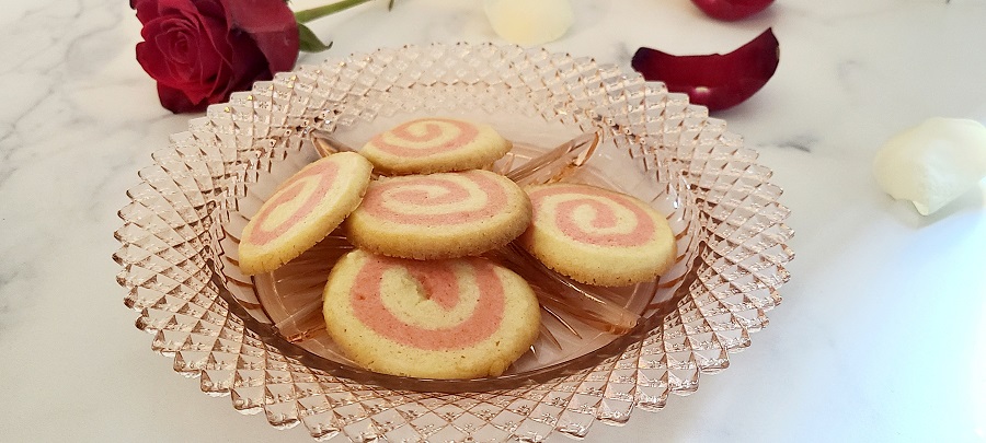 Pink Pinwheel Sugar Cookies on a Glass Plate with Rose Petals Around It