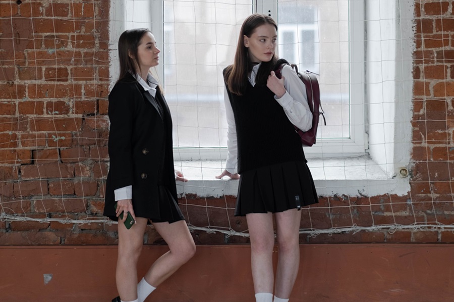 Best Netflix Series for Teens Two School Girls in School Uniforms Standing next to a Window