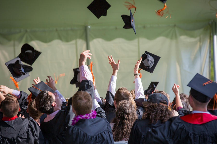 Graduation Quotes from Parents Graduates Standing Together Throwing Their Caps in the Air