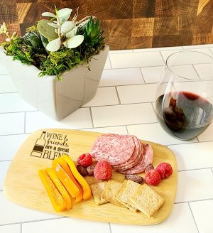 Personalized Mini Charcuterie Board Angled View of a Cheese Board with Meat, Crackers, and Cheese and a Glass of Wine
