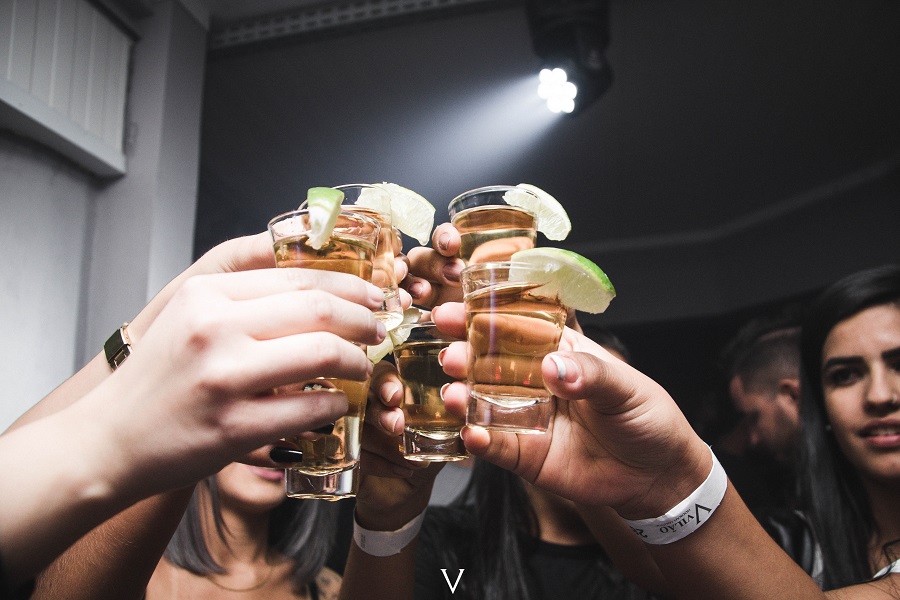 Tequila Drinks that Aren't Margaritas Close Up of a Gorup of People Raising Their Glasses Together with Lime Wedges on the Rim of Each Glass