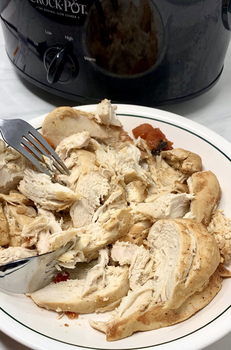 Crockpot Chicken Bowls Party Food Recipe Person Shredding Chicken on a Plate