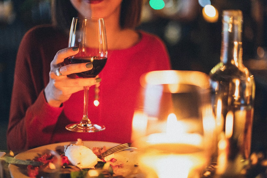 Easy Dinner Recipes For Two on a Date a Woman Sitting at a Table Holding a Wine Glass with Red Wine